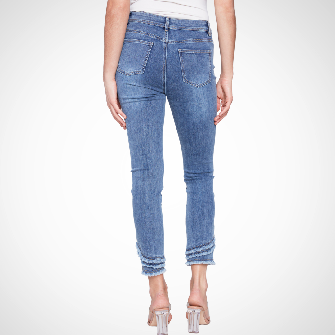 Jaboli Boutique - Fergus Ontario - Charlie B - Frayed Hem Jean - Medium Blue Colour. Frayed hem jeans in medium blue and natural hues Stretchy twill fabric for everyday comfort Practical and trendy wardrobe addition Versatile: easily dress up or down with a new top or change of footwear Mid-rise waist Skinny leg Five pockets Frayed hem detail