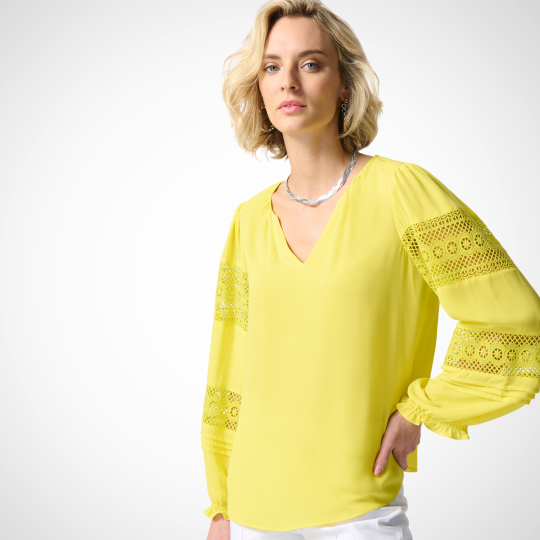 Jaboli Boutique - Fergus Ontario - Joseph Ribkoff  - Sunshine Georgette Puff Sleeve Blouse. Designer: Joseph Ribkoff Style: Bohemian elegance Neckline: Henley Color: Yellow Sunshine Sleeves: Puff sleeves with lace inserts Details: Billowy peasant top Delicate lace panels on sleeves Fabric: Lightweight for all-day comfort Occasion: Perfect for any occasion