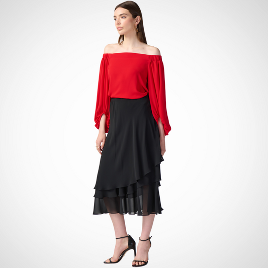 Jaboli Boutique - Fergus Ontario - Joseph Ribkoff - Tiered Midi Skirt. Designer: Joseph Ribkoff Style: Tiered skirt with cascading ruffles Color: Black Fit: Pull-on design Lining: Jersey lining to the knee Length: Cocktail length Material: Lightweight chiffon Made in: Canada Versatility: Pairs well with flowy blouses or form-fitting tank tops Occasion: Ideal for the summer months, adding an exotic flair to any outfit