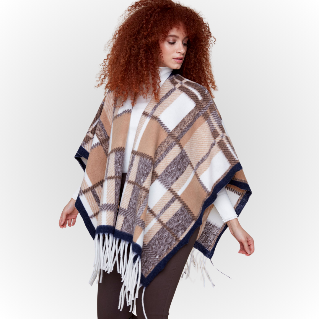 Jaboli Boutique-Fergus Ontario-Renuar-Plaid Poncho - Tan Plaid Poncho for fall Brushed knit plaid print Tan and peacock color combos Fringe hem detail Open front design Made from 100% acrylic One size fits most Stylish and cozy for crisp autumn days