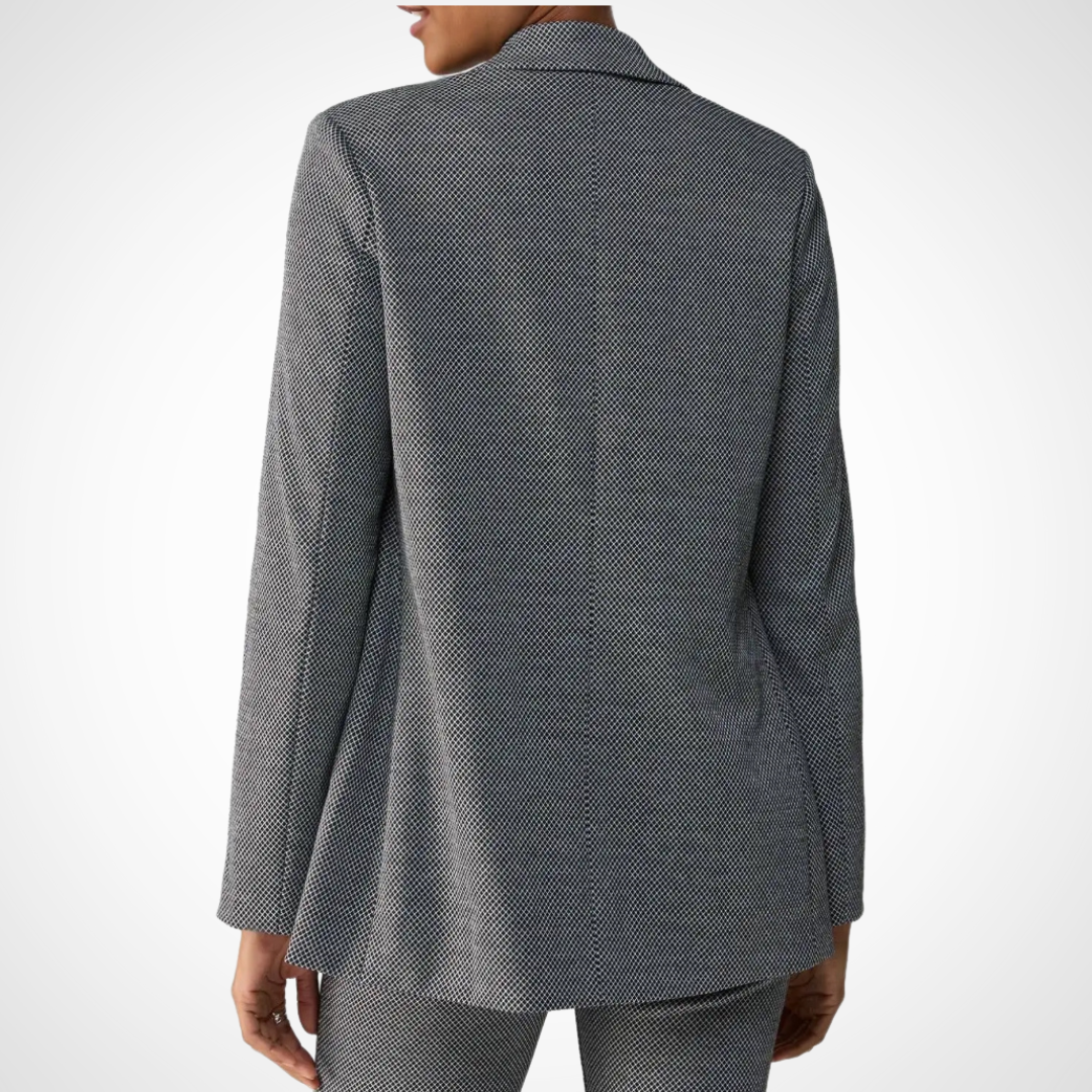 Jaboli Boutique - Fergus Ontario - Sanctuary - Keaton Blazer- Sanctuary Keaton Blazer exudes timeless elegance. Classic Double Breasted design in Geo Check color (black, light grey). Features a sophisticated Tuxedo Lapel. Comes with two pockets and long sleeves. Adds a refined touch to any outfit. Versatile; pairs well with matching pants for a polished look. Also coordinates seamlessly with favorite jeans for a casual vibe. Effortlessly elevates your style.
