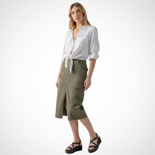 Jaboli Boutique - Fergus Ontario - The Sanctuary Triple Threat Skirt in Burnt Olive adds style to any outfit. It features a fly front and midi length with a front slit at the hem. This semi-high rise pencil midi skirt is comfortable and practical. It has two front and two back pockets for convenience. The button and zipper front closure ensure a secure fit. The relaxed fit adds to its appeal.